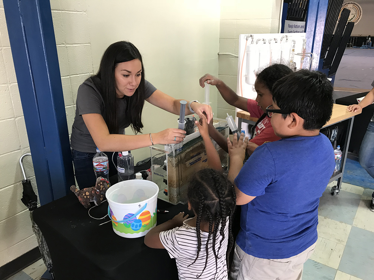 photo: Woman conducting aquifer demonstration for children